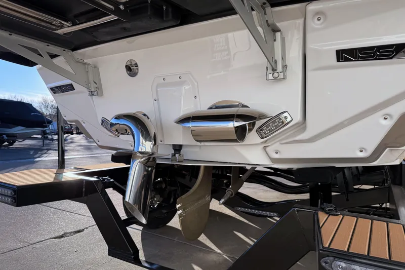 Slide: The Image of 2026 Nautique Super Air Nautique G25 boat stern with exhaust and propeller details. - 6