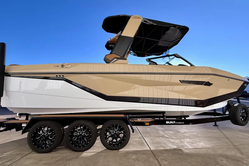 Slide: The Image of 2026 Nautique Super Air Nautique G25 boat on trailer, sleek design, beige and white color scheme. - 8
