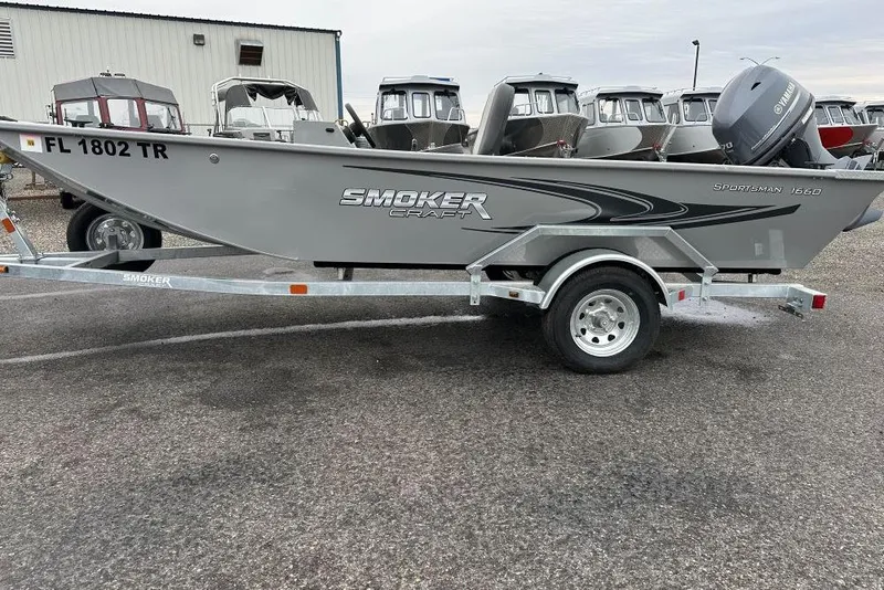 Slide: The Image of 2023 Smoker Craft Sportsman 1660 boat on trailer, parked outdoors. - 1