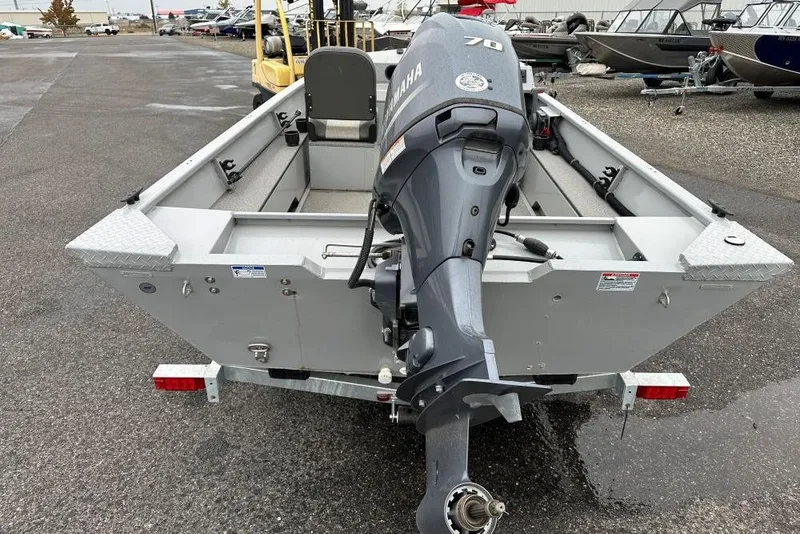 Slide: The Image of 2023 Smoker Craft Sportsman 1660 boat with Yamaha outboard motor, parked on a trailer. - 3