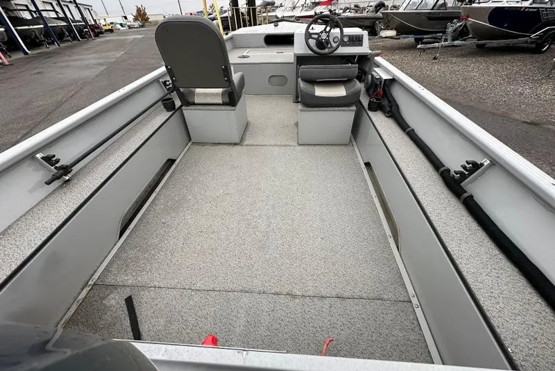 Slide: The Image of 2023 Smoker Craft Sportsman 1660 boat interior with seating and steering console. - 4