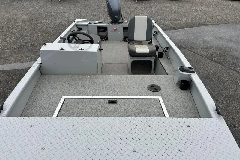 Slide: The Image of 2023 Smoker Craft Sportsman 1660 boat interior with steering console and seating. - 5