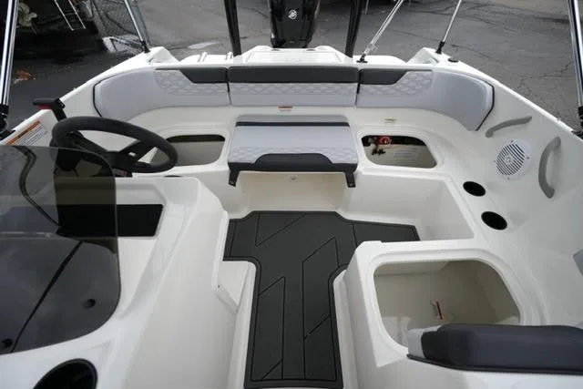Slide: The Image of 2026 Bayliner M17 boat interior with seating, steering wheel, and storage compartments. - 12