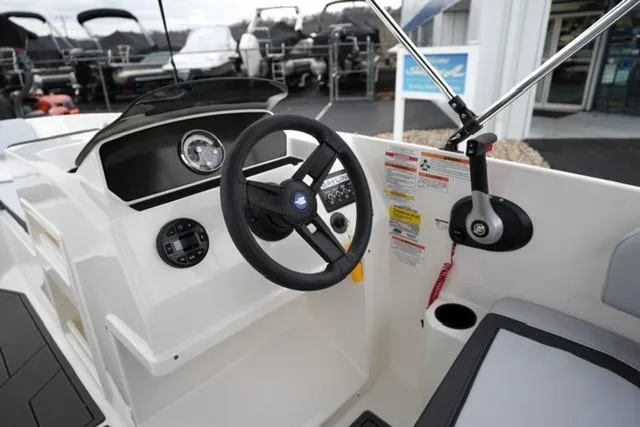 Slide: The Image of 2026 Bayliner M17 boat cockpit with steering wheel and control panel. - 13