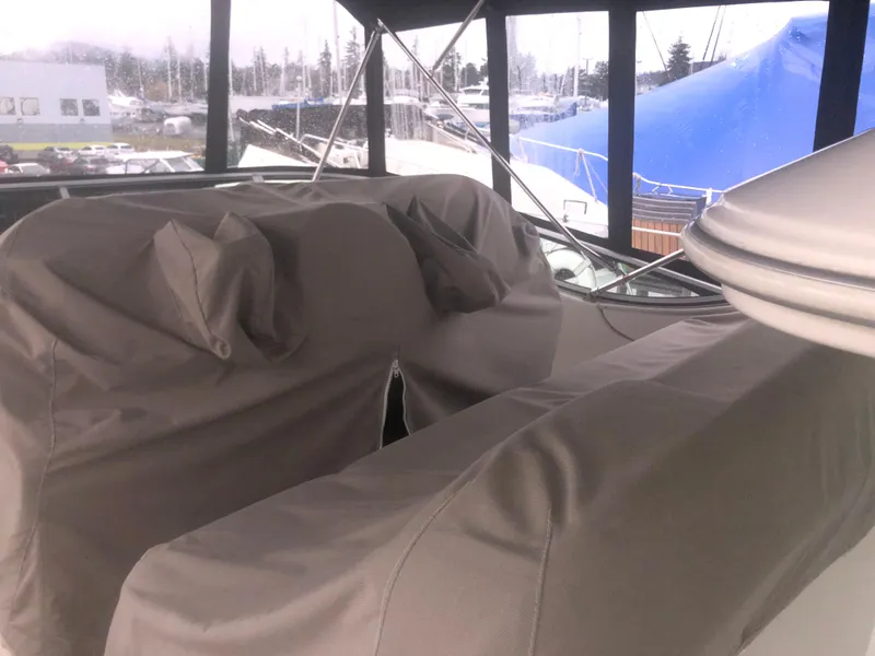 Slide: The Image of Covered seating area on a 2001 Maxum 4100 SCA yacht, docked at a marina. - 11