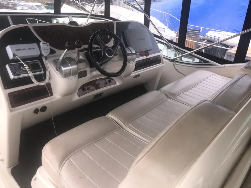 Slide: The Image of 2001 Maxum 4100 SCA yacht cockpit with steering wheel and control panel. - 13