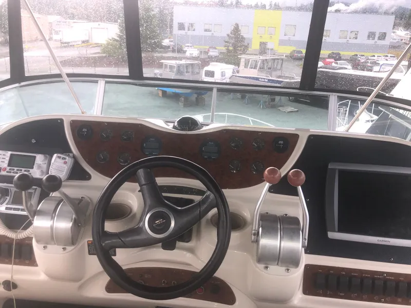Slide: The Image of 2001 Maxum 4100 SCA yacht helm with steering wheel, controls, and navigation equipment. - 16
