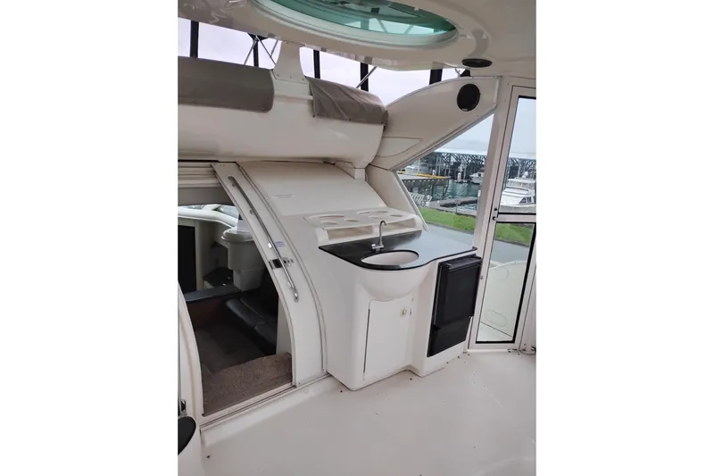 Slide: The Image of 2001 Maxum 4100 SCA yacht interior with kitchenette and outdoor view. - 18