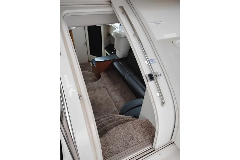 Slide: The Image of Interior view of 2001 Maxum 4100 SCA yacht, featuring carpeted stairs and seating area. - 19