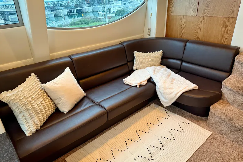 Slide: The Image of Luxurious interior of 2001 Maxum 4100 SCA yacht with leather seating and decorative pillows. - 23