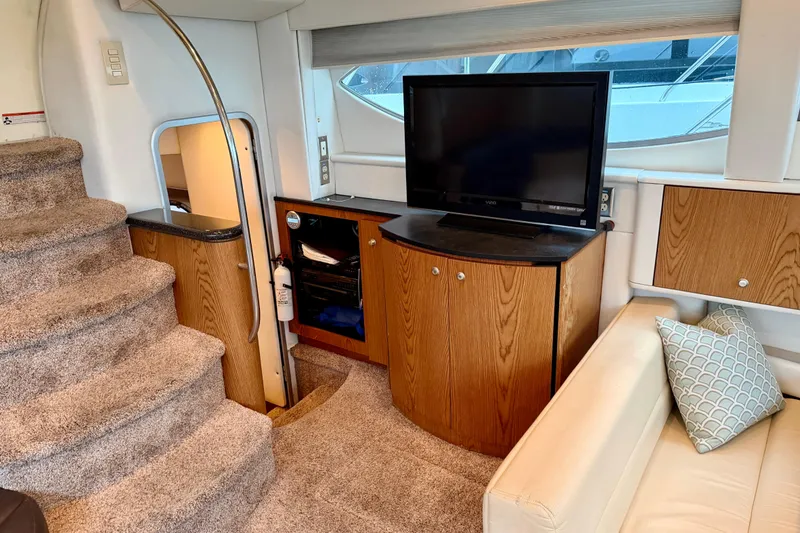 Slide: The Image of Interior of 2001 Maxum 4100 SCA yacht with TV, stairs, and cozy seating area. - 24