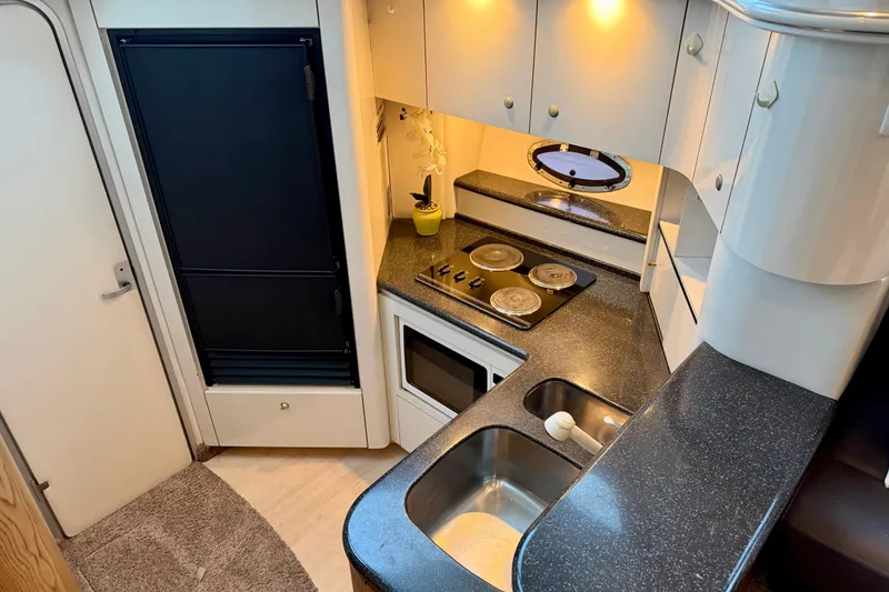 Slide: The Image of 2001 Maxum 4100 SCA yacht kitchen with modern appliances and sleek countertops. - 27