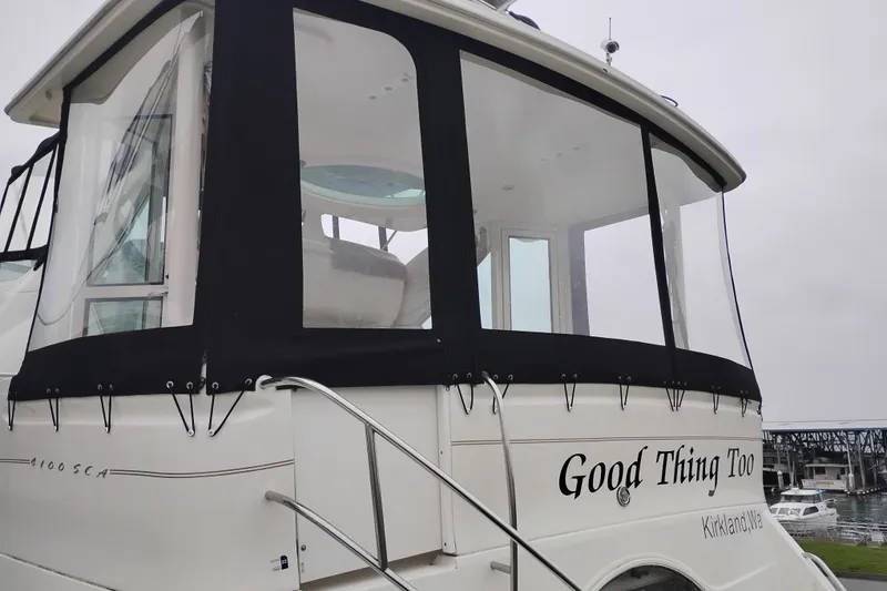 Slide: The Image of 2001 Maxum 4100 SCA yacht docked, featuring enclosed deck and "Good Thing Too" name. - 3