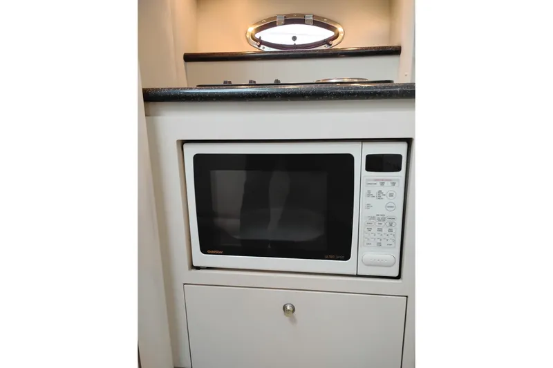 Slide: The Image of Microwave in 2001 Maxum 4100 SCA yacht kitchen with sleek countertop design. - 30