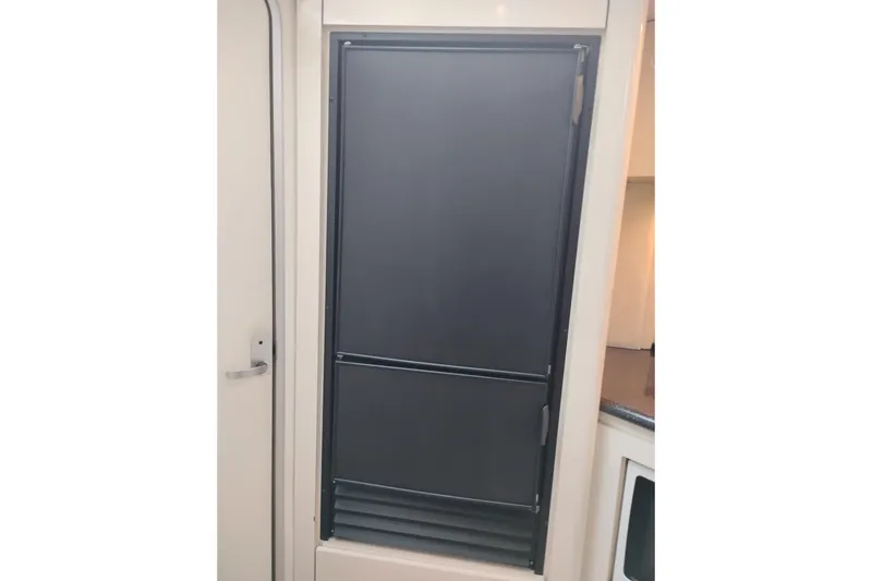 Slide: The Image of 2001 Maxum 4100 SCA interior with closed black panel door. - 31