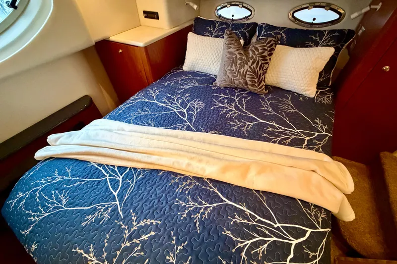 Slide: The Image of Luxurious cabin interior of 2001 Maxum 4100 SCA yacht with elegant bedding. - 32