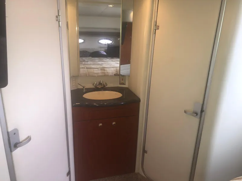 Slide: The Image of 2001 Maxum 4100 SCA yacht bathroom with sink, mirror, and storage cabinet. - 37