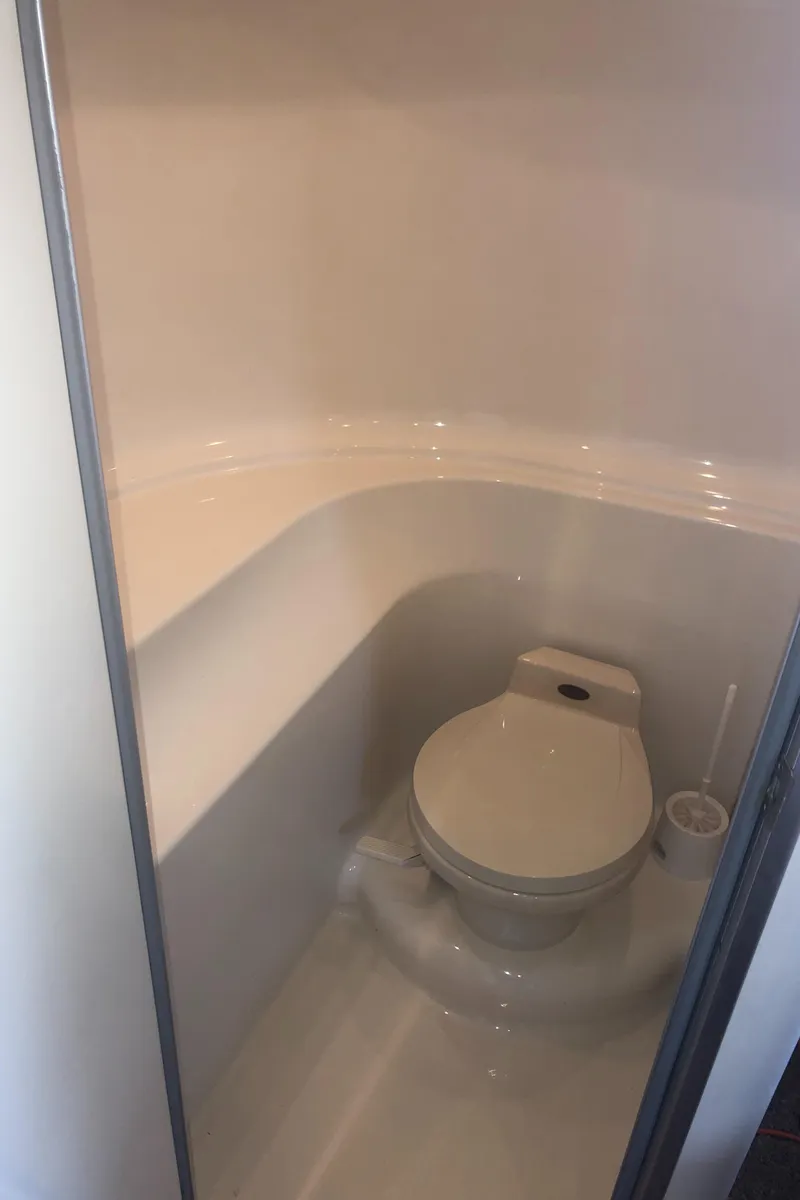 Slide: The Image of Bathroom in 2001 Maxum 4100 SCA yacht, featuring a compact marine toilet. - 39