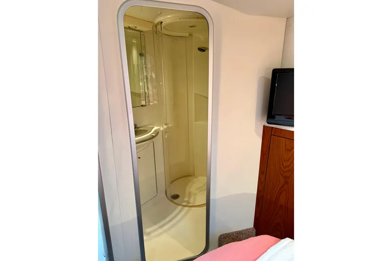 Slide: The Image of 2001 Maxum 4100 SCA yacht interior with compact shower and wooden cabinetry. - 45