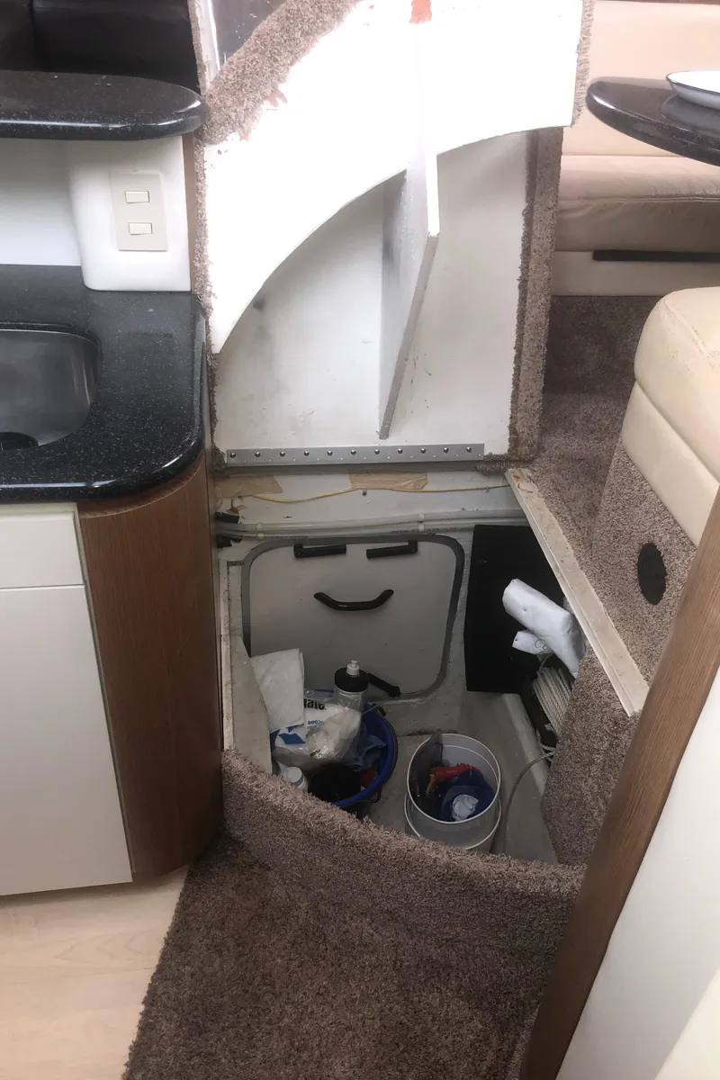 Slide: The Image of Interior of a 2001 Maxum 4100 SCA yacht showing storage compartment and seating area. - 47