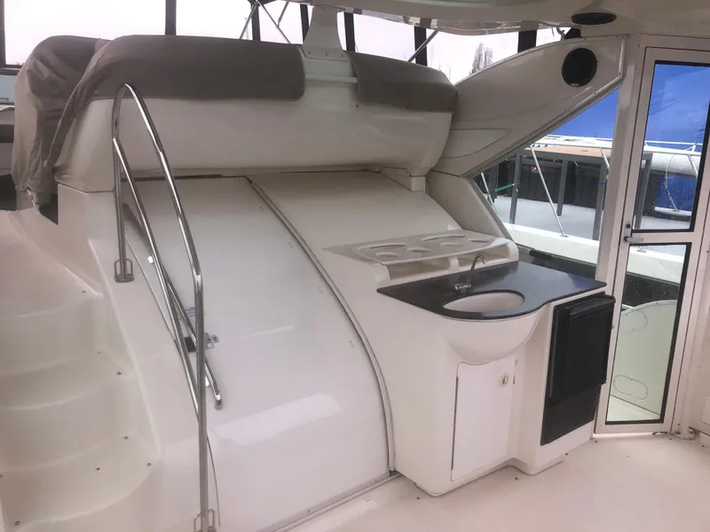 Slide: The Image of 2001 Maxum 4100 SCA yacht interior with stairs, seating, and kitchenette area. - 7