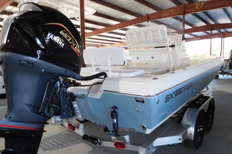 Slide: The Image of 2026 Skeeter SX230 boat with Yamaha engine in a covered storage area. - 3