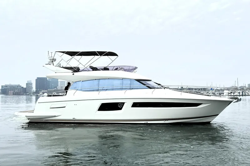 The Image of 2017 Prestige 500 yacht on calm water with city skyline background. - 0