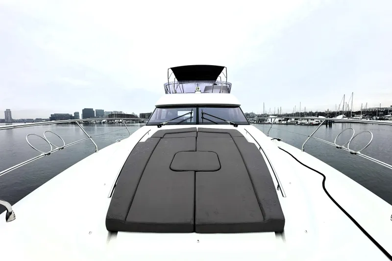 Slide: The Image of 2017 Prestige 500 yacht on calm water, showcasing sleek design and spacious deck. - 17