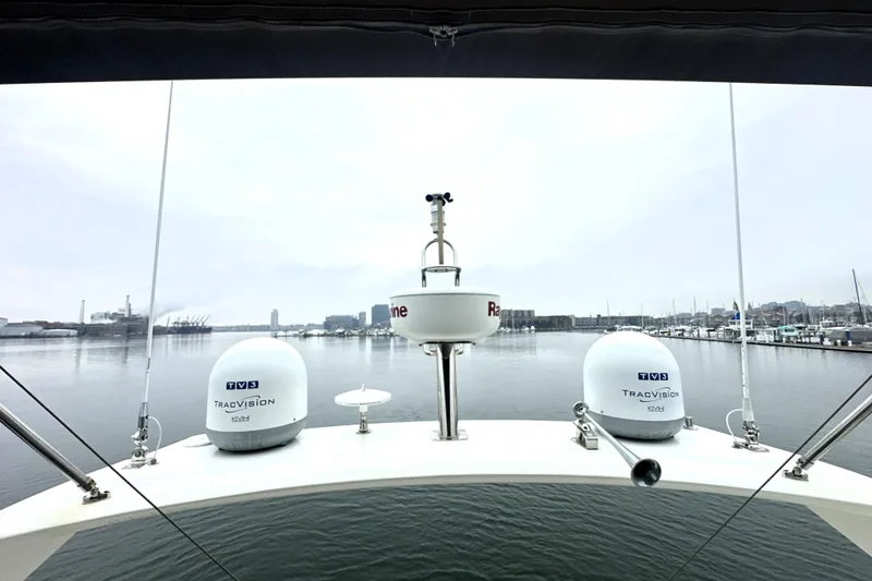 Slide: The Image of 2017 Prestige 500 yacht with TracVision domes and Raymarine equipment, docked in a calm harbor. - 21