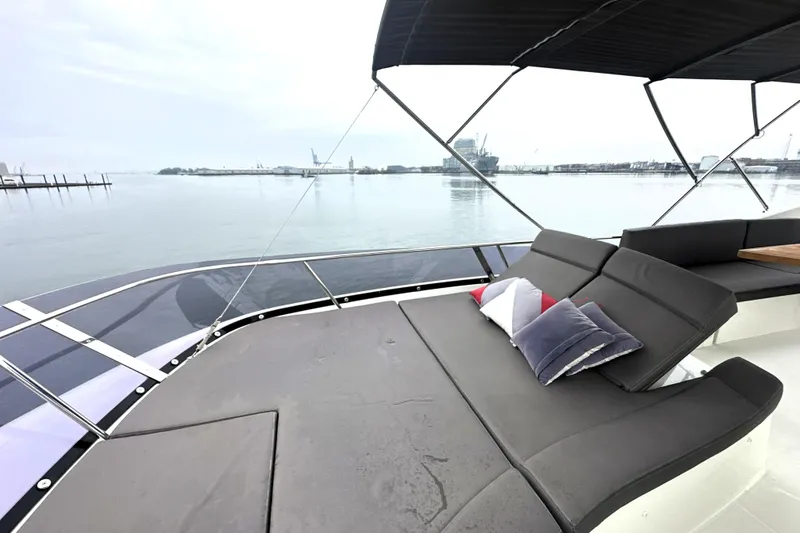 Slide: The Image of Luxurious 2017 Prestige 500 yacht deck with comfortable seating and scenic waterfront view. - 22