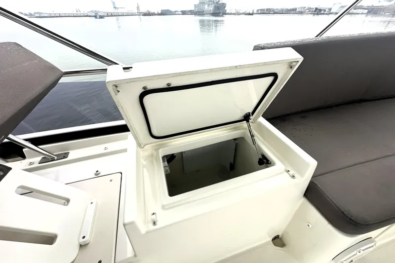 Slide: The Image of Open storage compartment on 2017 Prestige 500 yacht, with water view in background. - 28