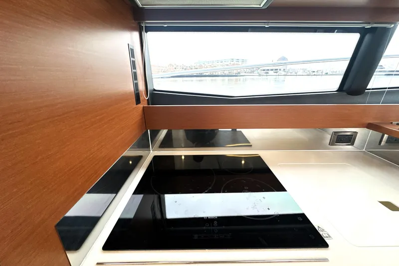Slide: The Image of Modern kitchen interior of 2017 Prestige 500 yacht with sleek cooktop and wood finish. - 35