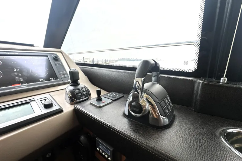 Slide: The Image of Control panel of a 2017 Prestige 500 yacht with navigation and throttle controls. - 47