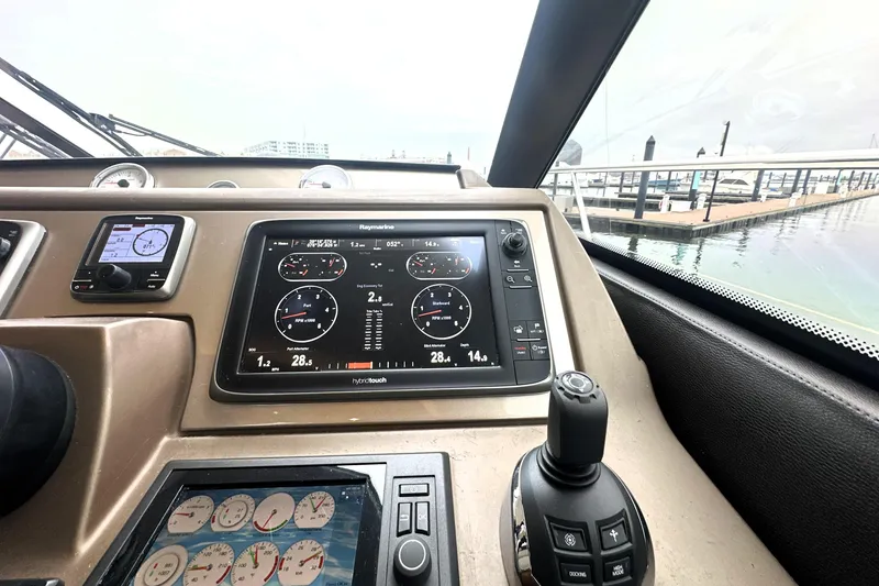Slide: The Image of Control panel of a 2017 Prestige 500 yacht with navigation displays and joystick. - 48