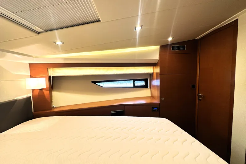 Slide: The Image of Luxurious interior cabin of a 2017 Prestige 500 yacht, featuring modern design and ambient lighting. - 54