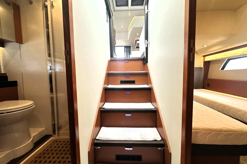 Slide: The Image of Interior of 2017 Prestige 500 yacht showing stairs, bathroom, and bedroom. - 59