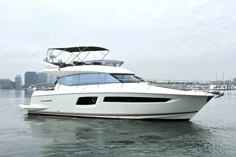 Slide: The Image of 2017 Prestige 500 yacht on calm water with city skyline in background. - 6