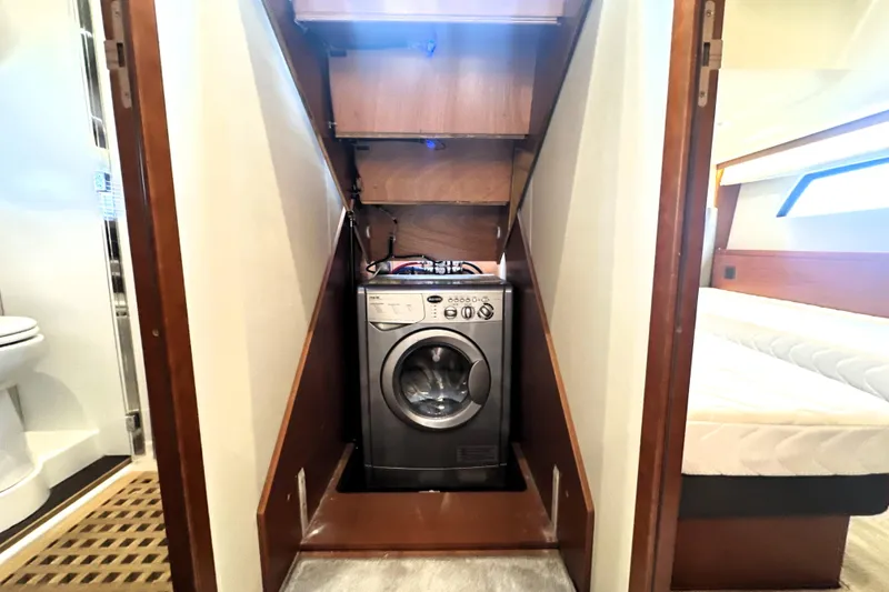 Slide: The Image of Laundry area with washing machine in 2017 Prestige 500 yacht interior. - 60