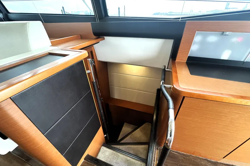 Slide: The Image of Interior stairs of a 2017 Prestige 500 yacht, featuring sleek wood and leather finishes. - 61