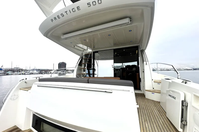 Slide: The Image of 2017 Prestige 500 yacht with open deck, docked at marina, showcasing luxury design. - 8