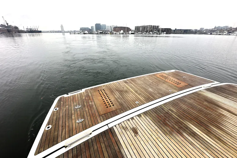 Slide: The Image of Wooden deck of a 2017 Prestige 500 yacht overlooking a calm harbor. - 9