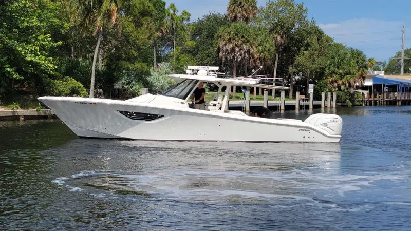 Slide: The Image of 2021 Pursuit S 378 Sport boat cruising on a calm river. - 13