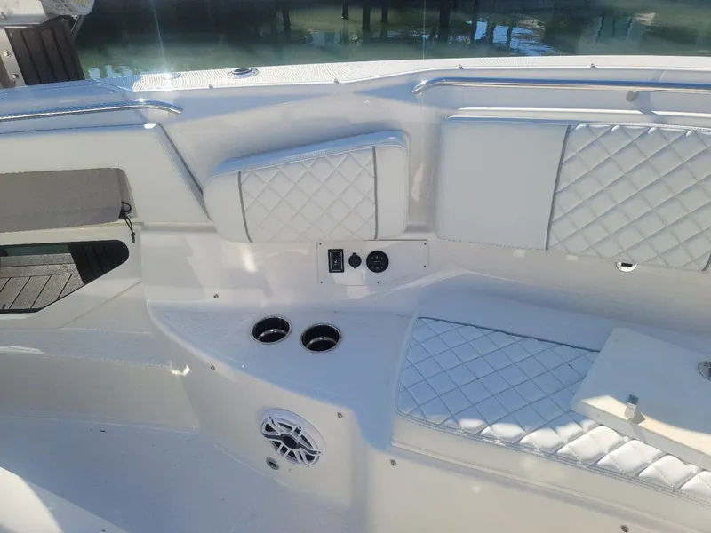 Slide: The Image of 2021 Pursuit S 378 Sport boat interior with quilted seating and cup holders. - 26
