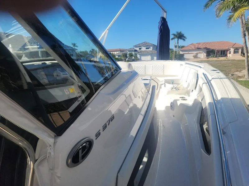 Slide: The Image of 2021 Pursuit S 378 Sport boat docked under clear blue sky. - 28
