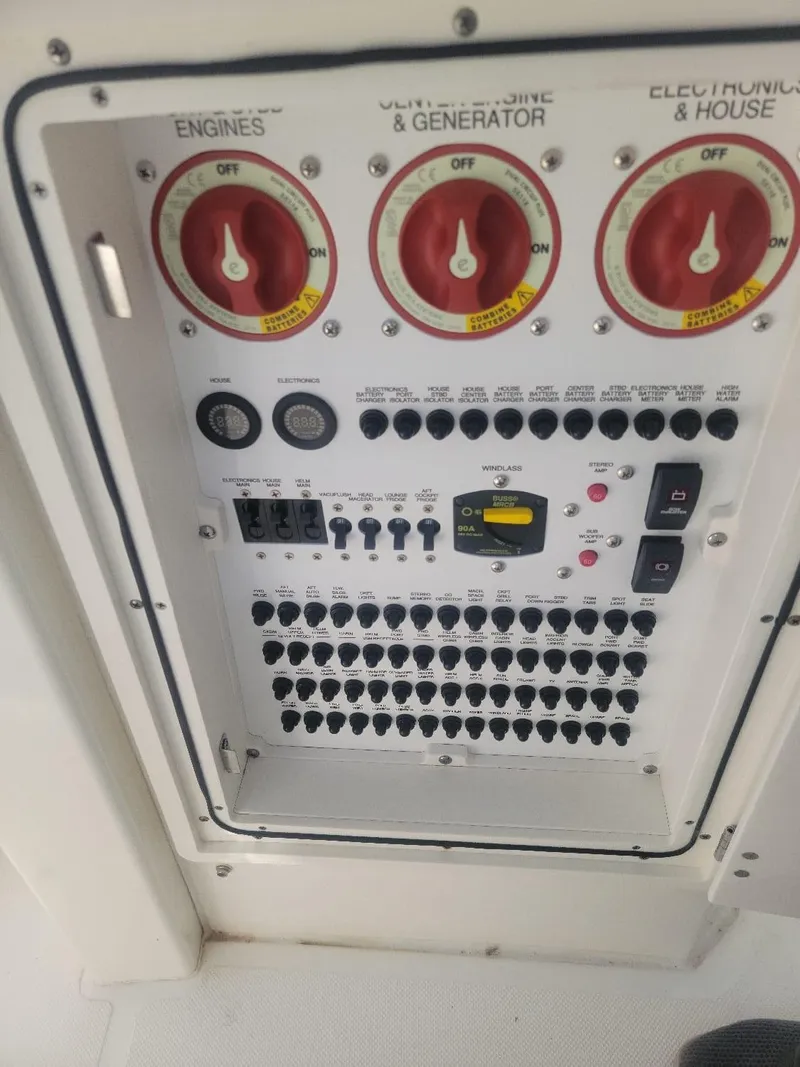 Slide: The Image of Control panel of a 2021 Pursuit S 378 Sport boat, featuring engine and generator switches. - 32