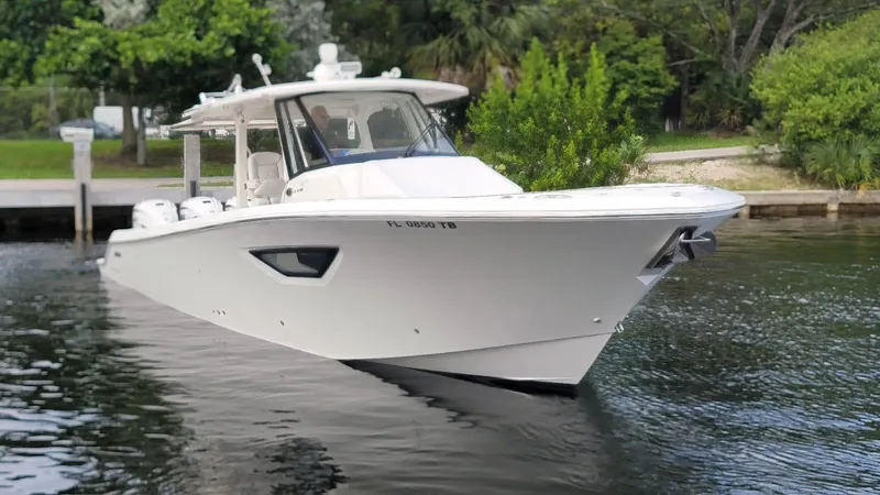 Slide: The Image of 2021 Pursuit S 378 Sport boat on calm water near a dock. - 4