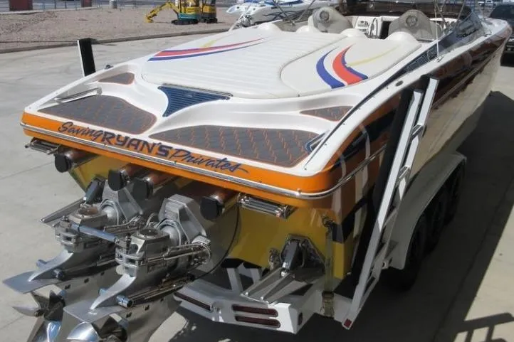 Slide: The Image of 2013 Nordic 39 POKER RUN speedboat with vibrant graphics and dual engines. - 2