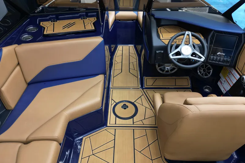 Slide: The Image of 2024 ATX Surf Boats 22 Type-S interior with tan and blue seating, modern dashboard, and stylish flooring. - 10