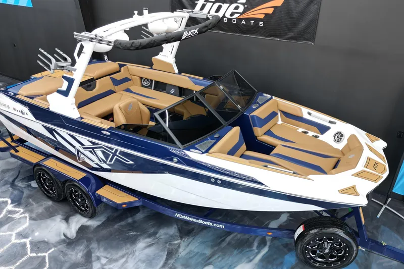 Slide: The Image of 2024 ATX Surf Boats 22 Type-S, blue and tan interior, on display indoors. - 3