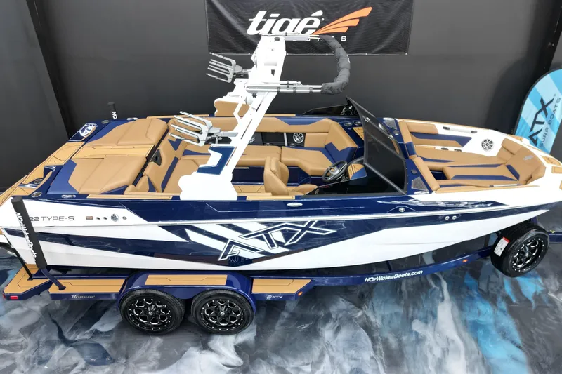 Slide: The Image of 2024 ATX Surf Boats 22 Type-S, sleek design, blue and tan interior, on display. - 4